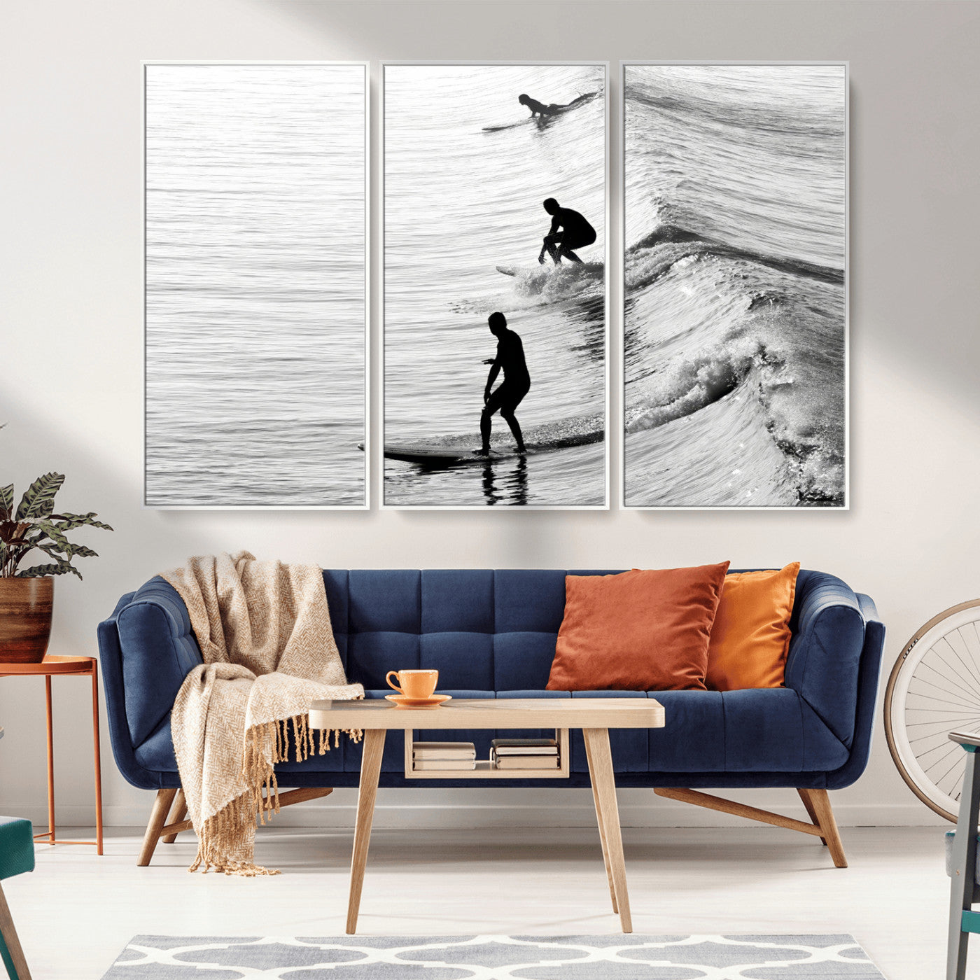 Black and white photo of surfers riding waves in a moody, high-contrast scene, ideal for modern coastal or surf-inspired home decor.