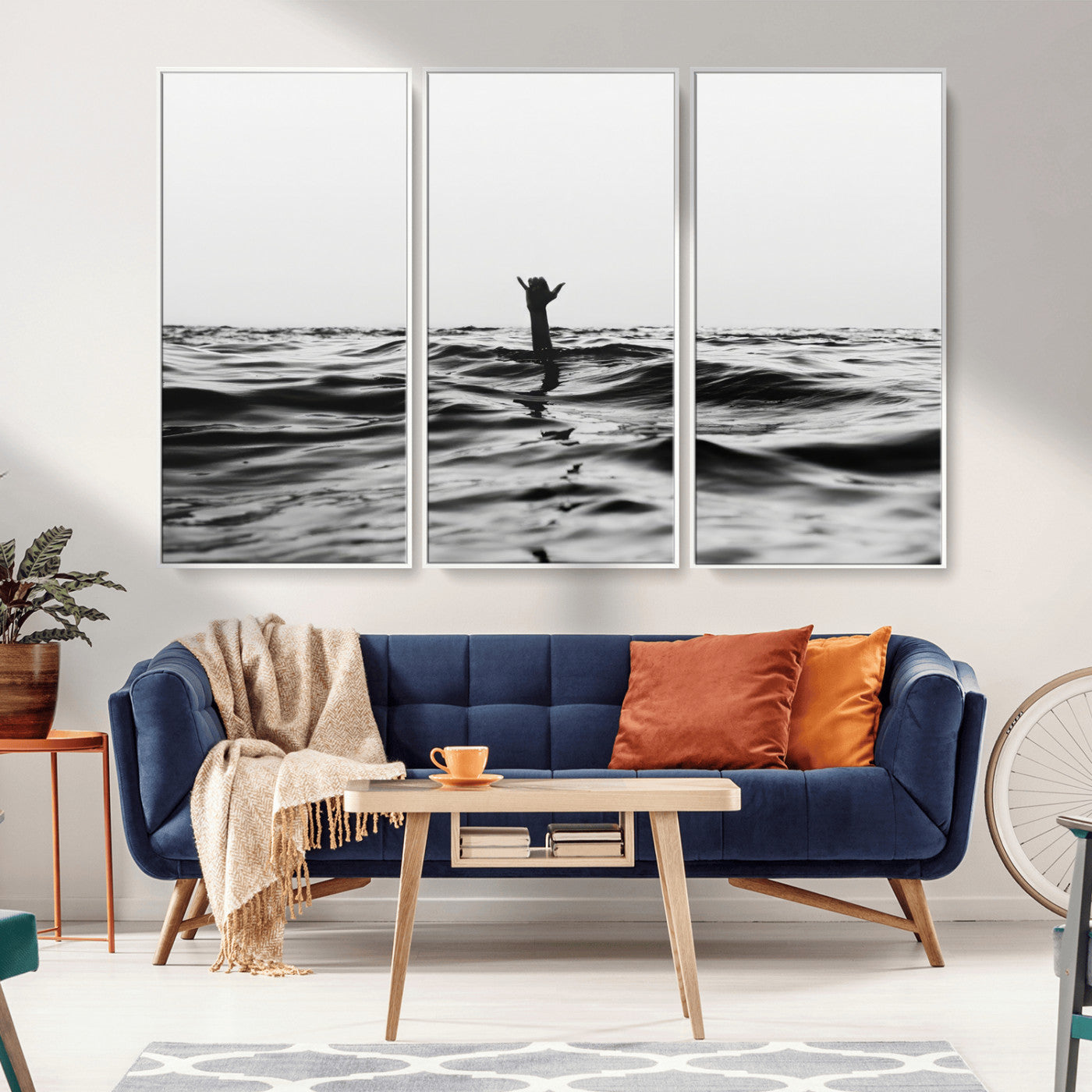 Black and white ocean with a hand making a surfer sign among dark waves, creating a dramatic and minimalist seascape with bold contrast.