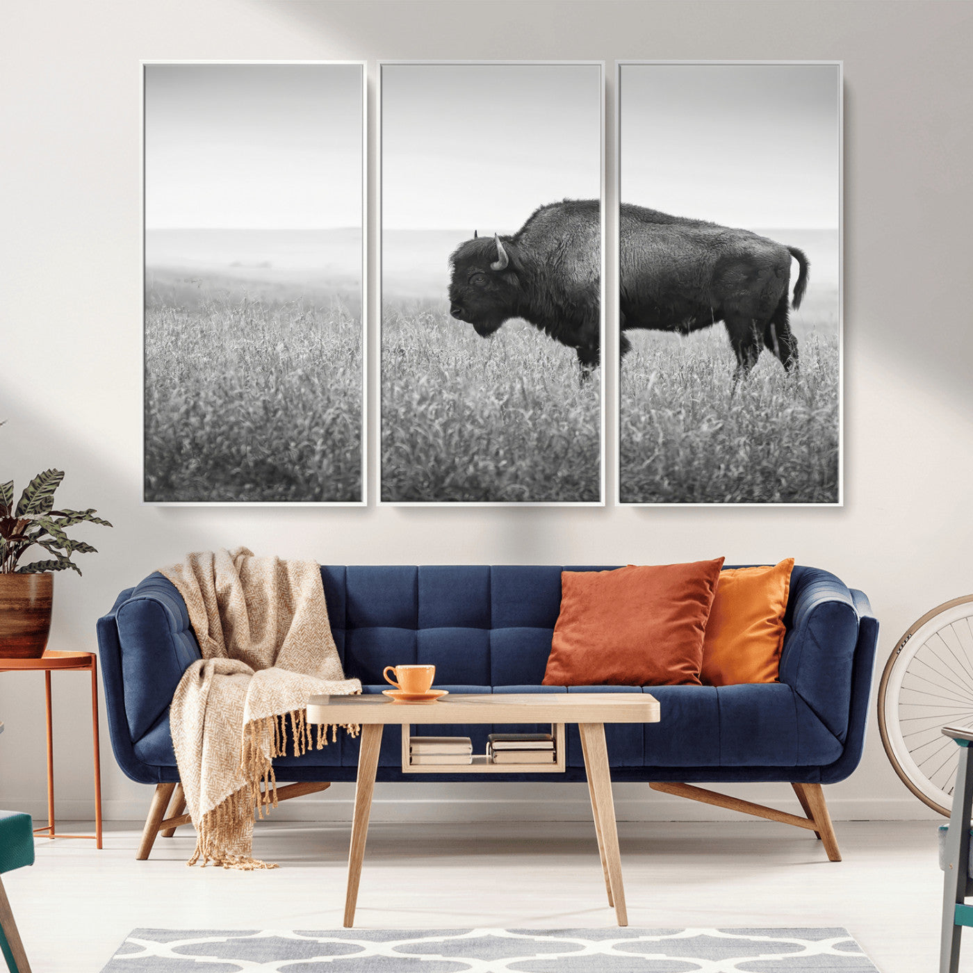 A black and white photograph of a majestic bison standing in a vast grassy prairie, evoking a sense of wilderness and strength.