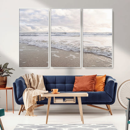 Peaceful ocean waves rolling onto the sandy shore under soft light, perfect for neutral or coastal minimalist decor themes.
