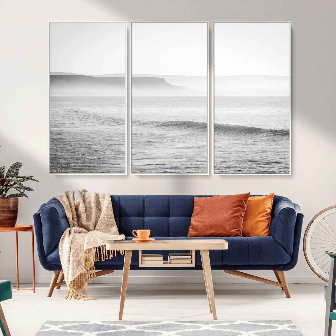 A black and white minimalist seascape featuring soft rolling waves and misty distant cliffs, creating a serene and timeless coastal atmosphere.