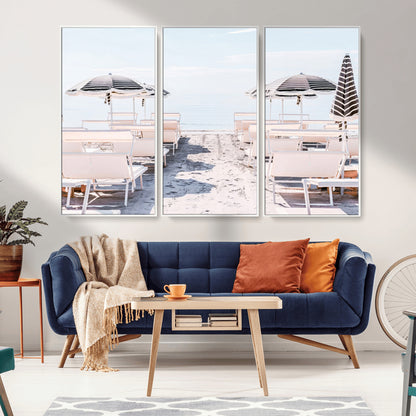 A serene minimalist beach scene featuring striped umbrellas, soft pastel sand, and an elegant lounge setup, creating a tranquil and stylish coastal retreat.