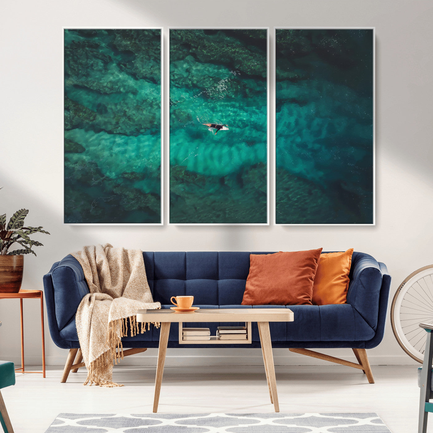 An aerial view of a solo surfer paddling through crystal-clear turquoise waters over a sunlit reef, capturing the beauty and serenity of open water surfing.