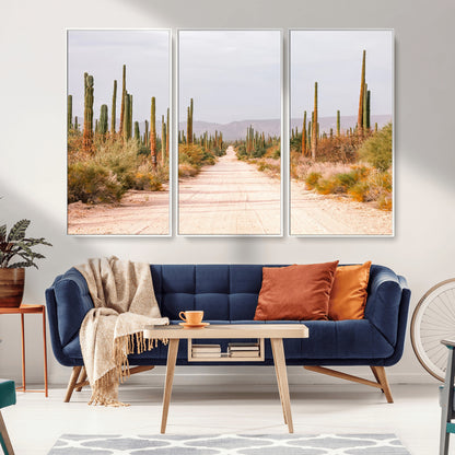 A desert road lined with saguaro cacti under a golden sky, creating a warm southwestern feel, perfect for boho or rustic decor.