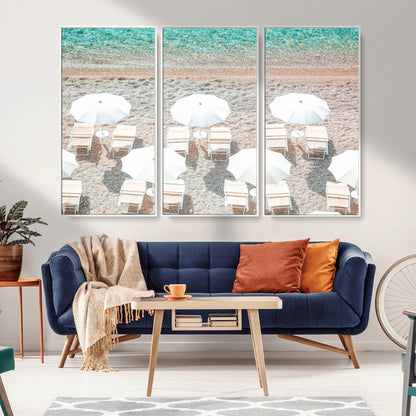 A bright beach scene with white umbrellas, pastel sand, and turquoise waters, creating a tranquil coastal vibe, perfect for beach house or summer decor.