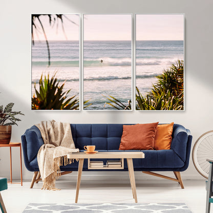 Canvas of a lone surfer riding a pastel wave at sunrise, perfect for tropical or coastal-themed spaces with a relaxed, airy vibe.