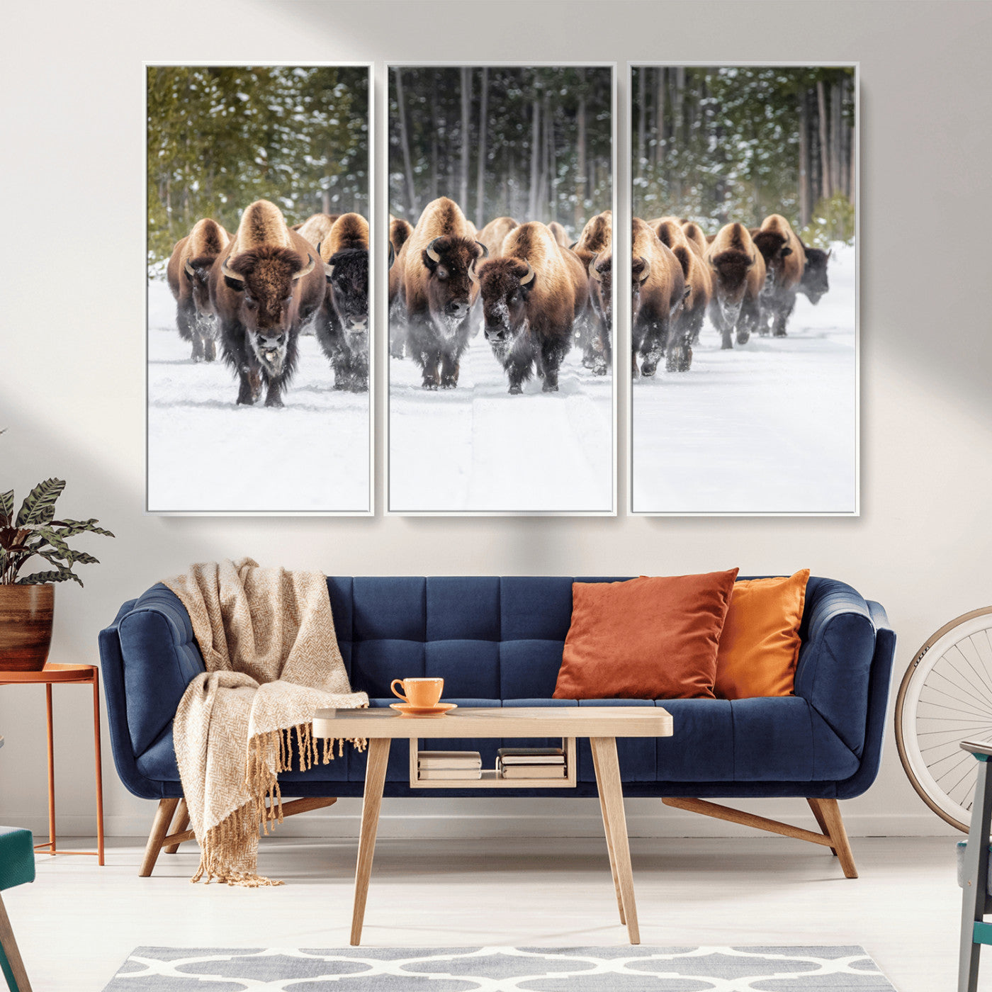 A herd of American bisons walking through a snowy forest path, perfect for rustic cabin or Western-themed wall decor.