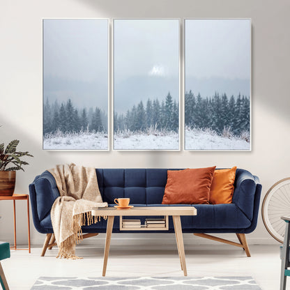 Snow-covered forest under misty sky, soft light breaking through clouds, ideal for minimalist or Nordic-inspired home decor.