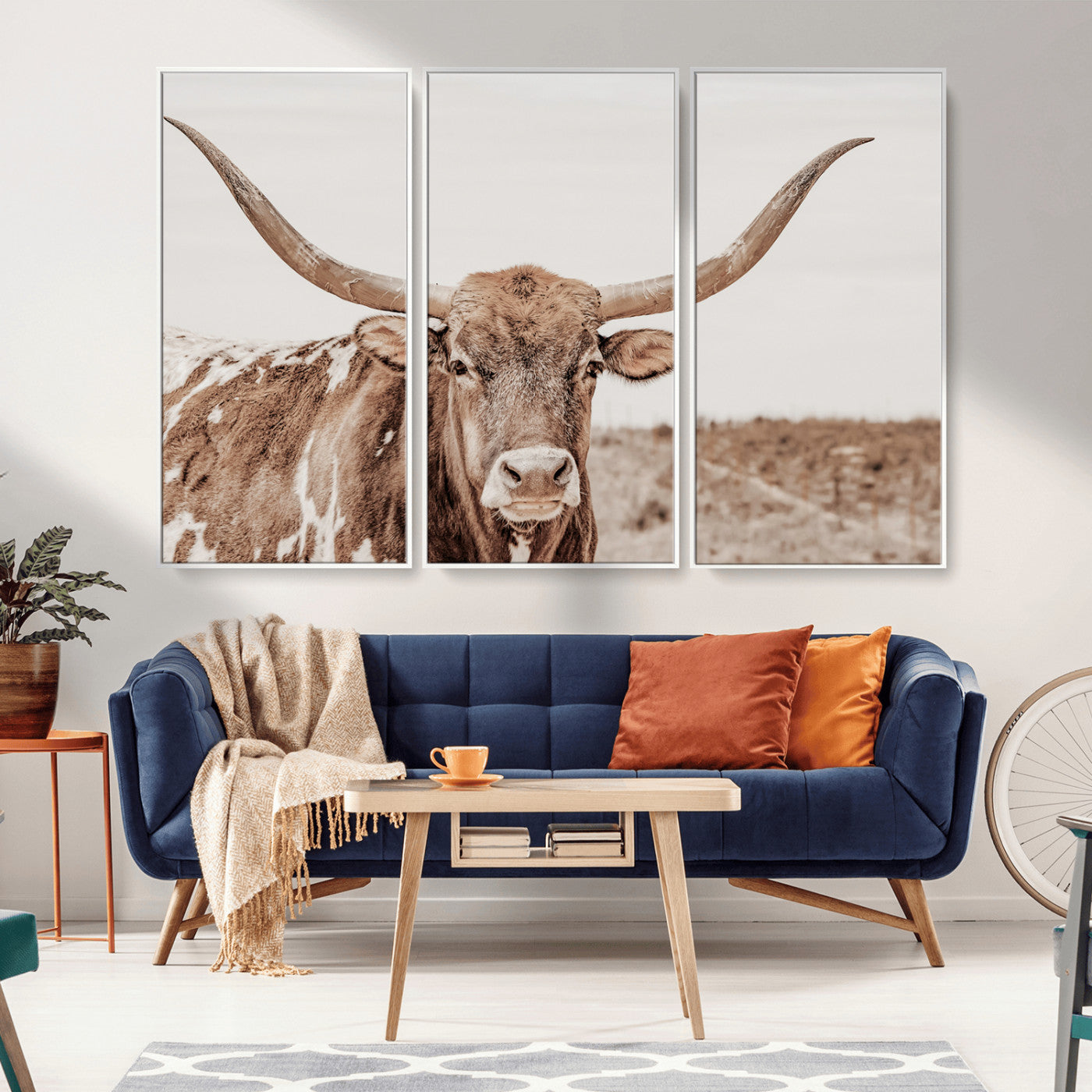 A longhorn cow in soft beige desert tones, standing calmly in open land, perfect for neutral western or rustic farmhouse interiors.