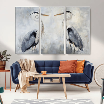 Two herons facing each other on a soft-toned background with blue-grey feathers, perfect for tranquil, coastal or nature-themed interiors.