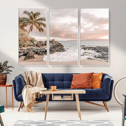 A peaceful beach scene with a palm tree and rocks, soft waves washing onto the shore under a soft pastel sky at sunset.