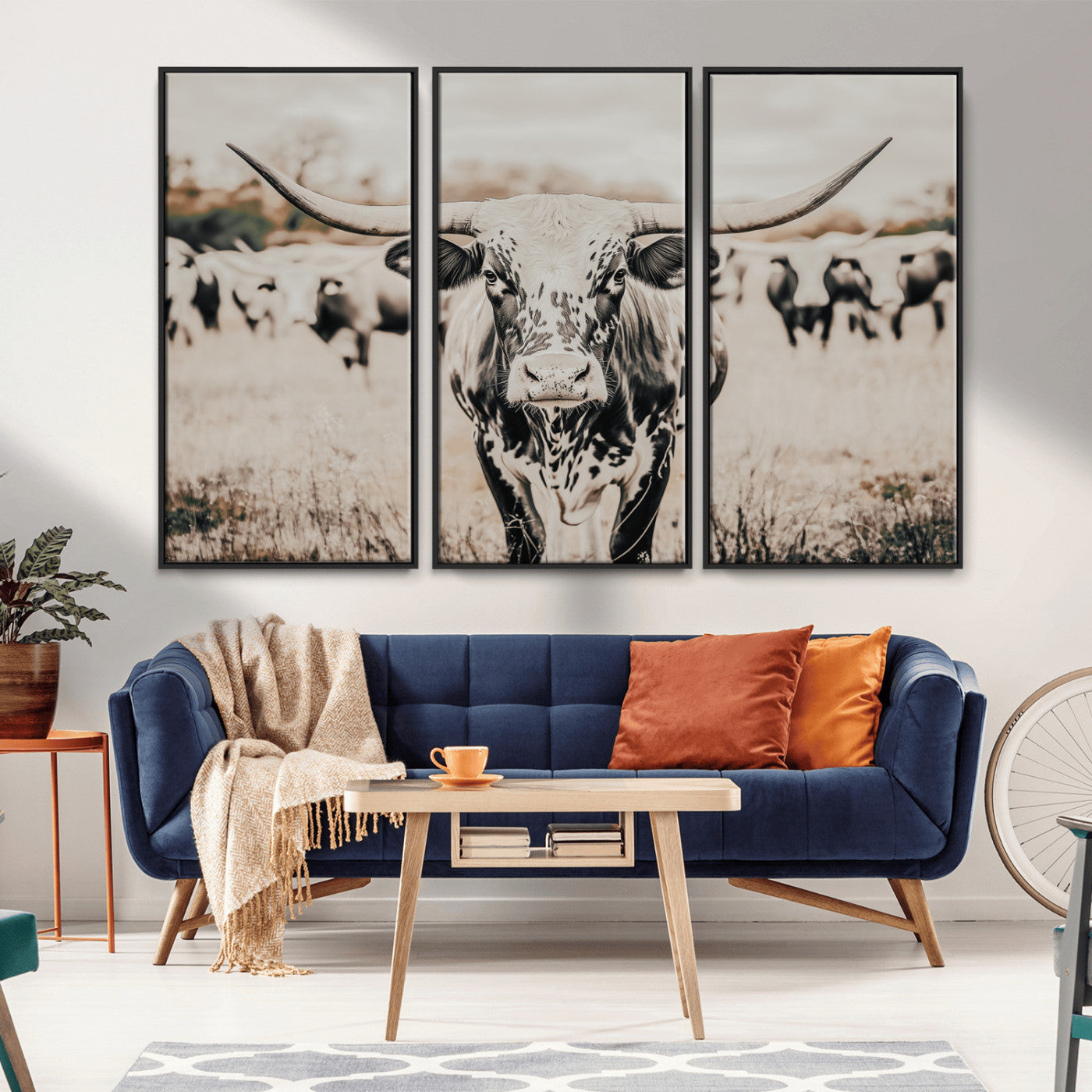 Canvas of a speckled Texas longhorn standing boldly in a field with a herd behind, perfect for rustic western or farmhouse wall decor.