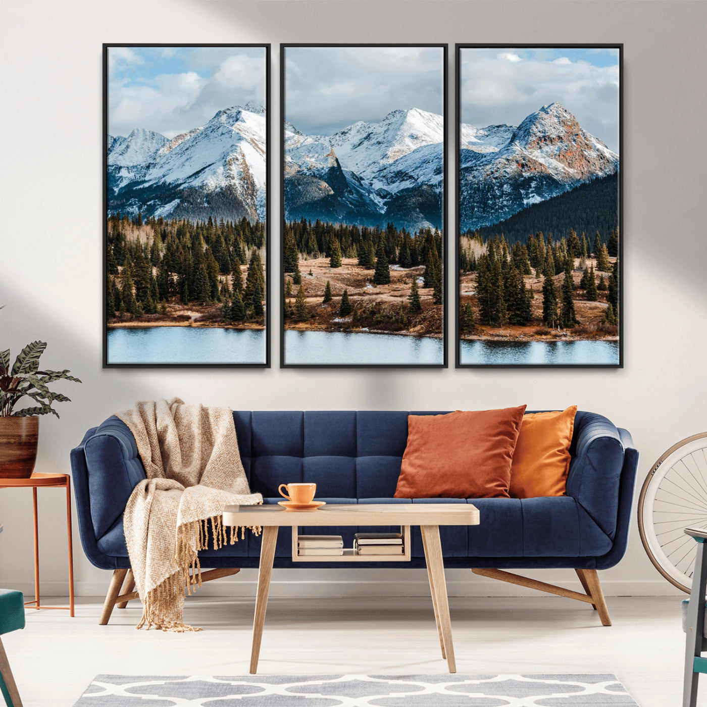 Framed canvas of snowy mountain peaks with pine forest and alpine lake, perfect for winter cabin or wilderness-inspired home decor.