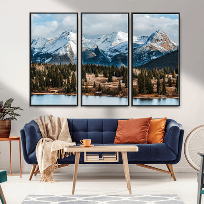 Framed canvas of snowy mountain peaks with pine forest and alpine lake, perfect for winter cabin or wilderness-inspired home decor.