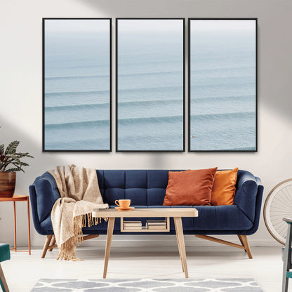 Framed canvas of repeating ocean waves with a distant solo surfer, ideal for minimalist ocean or calm coastal wall decor.