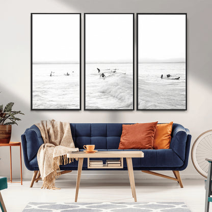 Monochrome photo of surfers riding and waiting on ocean waves, ideal for surf-themed or coastal energy wall decor.