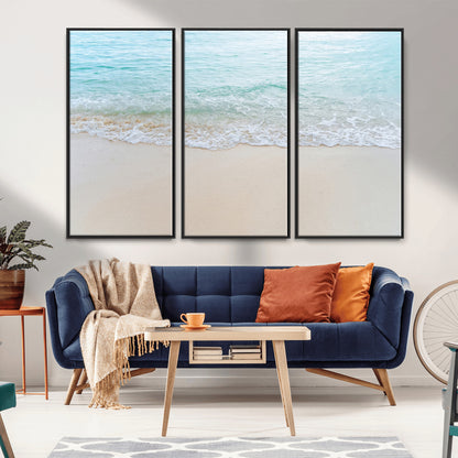 Soft shoreline with gentle aqua waves on smooth sand, ideal for minimalist coastal or pastel ocean-inspired home wall decor.