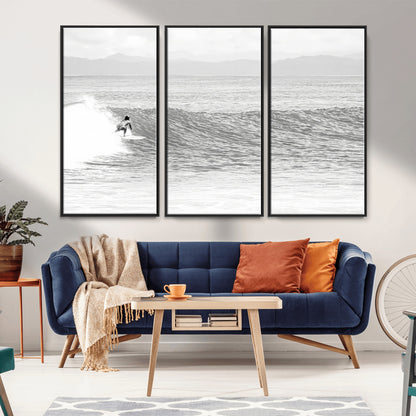 Monochrome photo of a surfer riding a wave with distant mountains, ideal for coastal motion or black and white surf-themed wall decor.