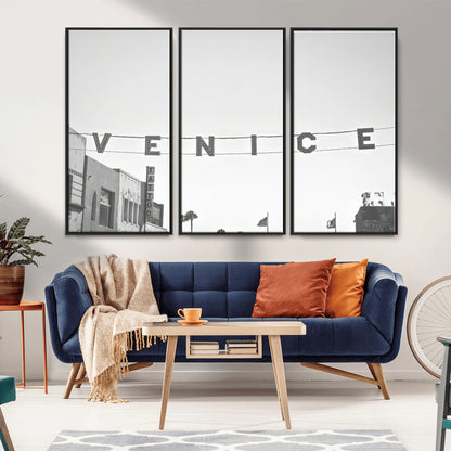Black and white photo of Venice Beach sign and palm-lined street, perfect for urban coastal or minimalist LA-inspired wall decoration.