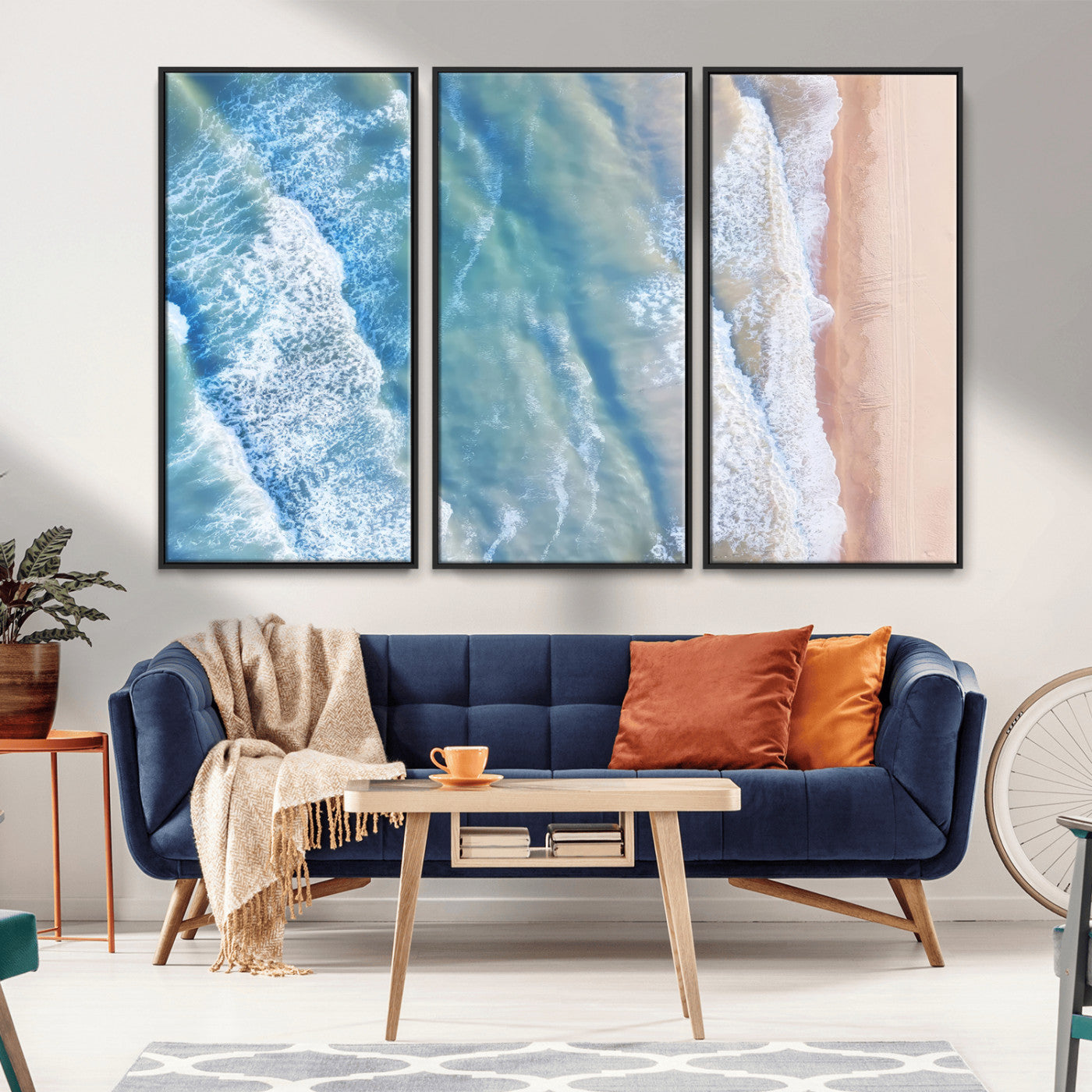 Aerial photo of soft blue waves meeting sandy shore, perfect for modern coastal or beach-themed decor with a light and tranquil aesthetic.