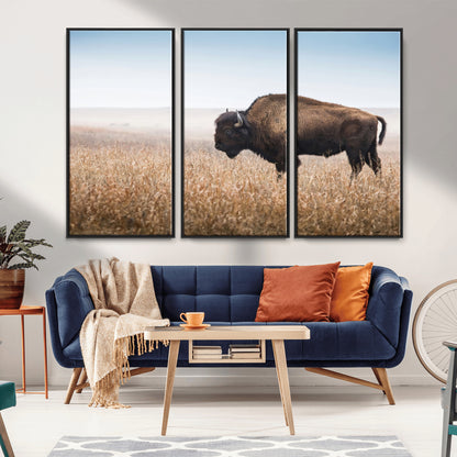 A majestic bison standing in an open prairie field, its strong form blending into the golden grass under a vast blue sky, evoking the wild spirit of the American plains.