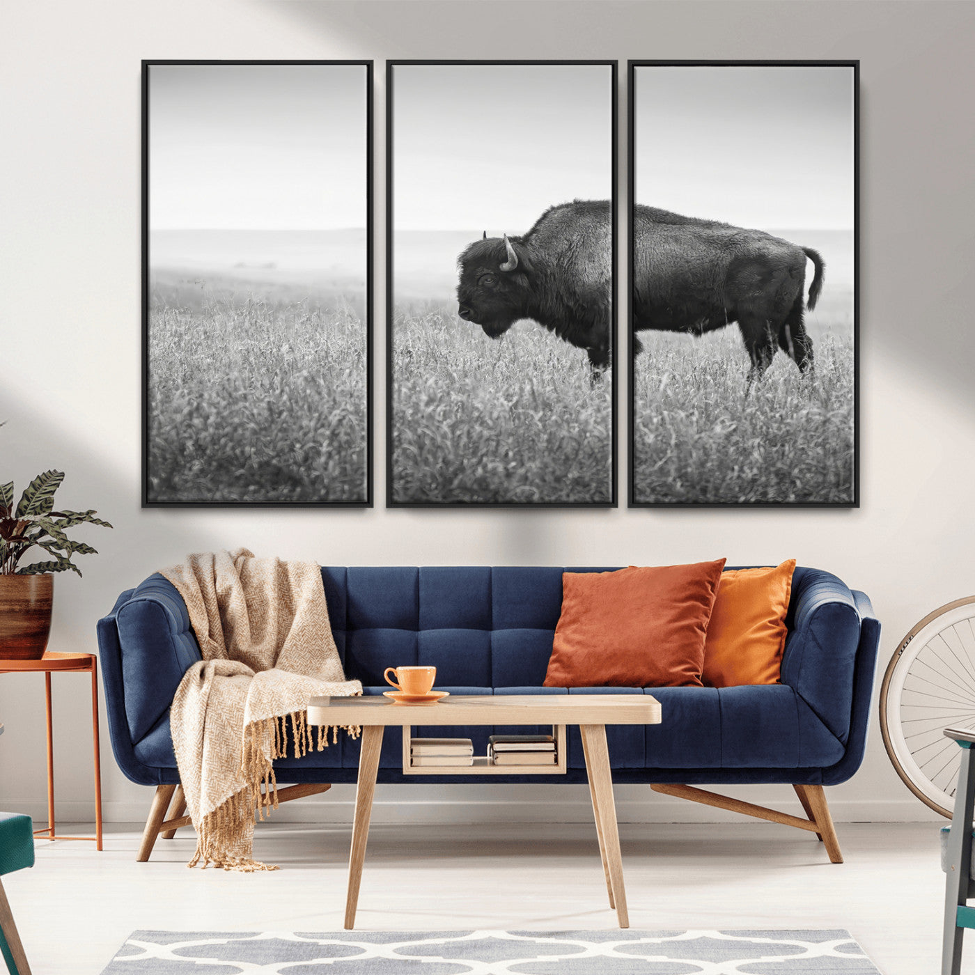 A black and white photograph of a majestic bison standing in a vast grassy prairie, evoking a sense of wilderness and strength.