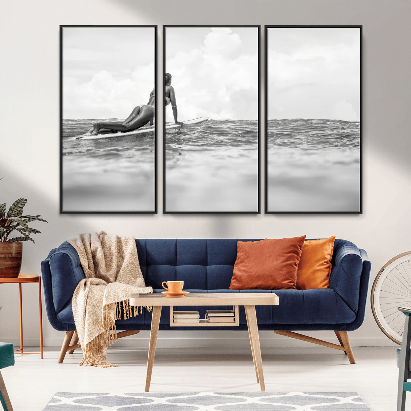 A black and white ocean scene featuring a surfer girl waiting on her board, gazing at the horizon, capturing a tranquil and adventurous coastal moment.