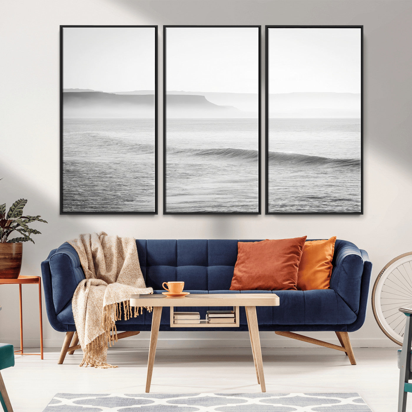 A black and white minimalist seascape featuring soft rolling waves and misty distant cliffs, creating a serene and timeless coastal atmosphere.
