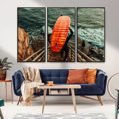 A surfer carrying a bold orange surfboard down a rugged staircase toward the ocean, bathed in golden hour light, capturing the energy of coastal adventure.