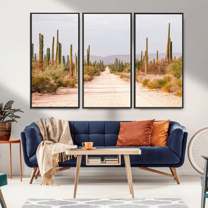 A desert road lined with saguaro cacti under a golden sky, creating a warm southwestern feel, perfect for boho or rustic decor.