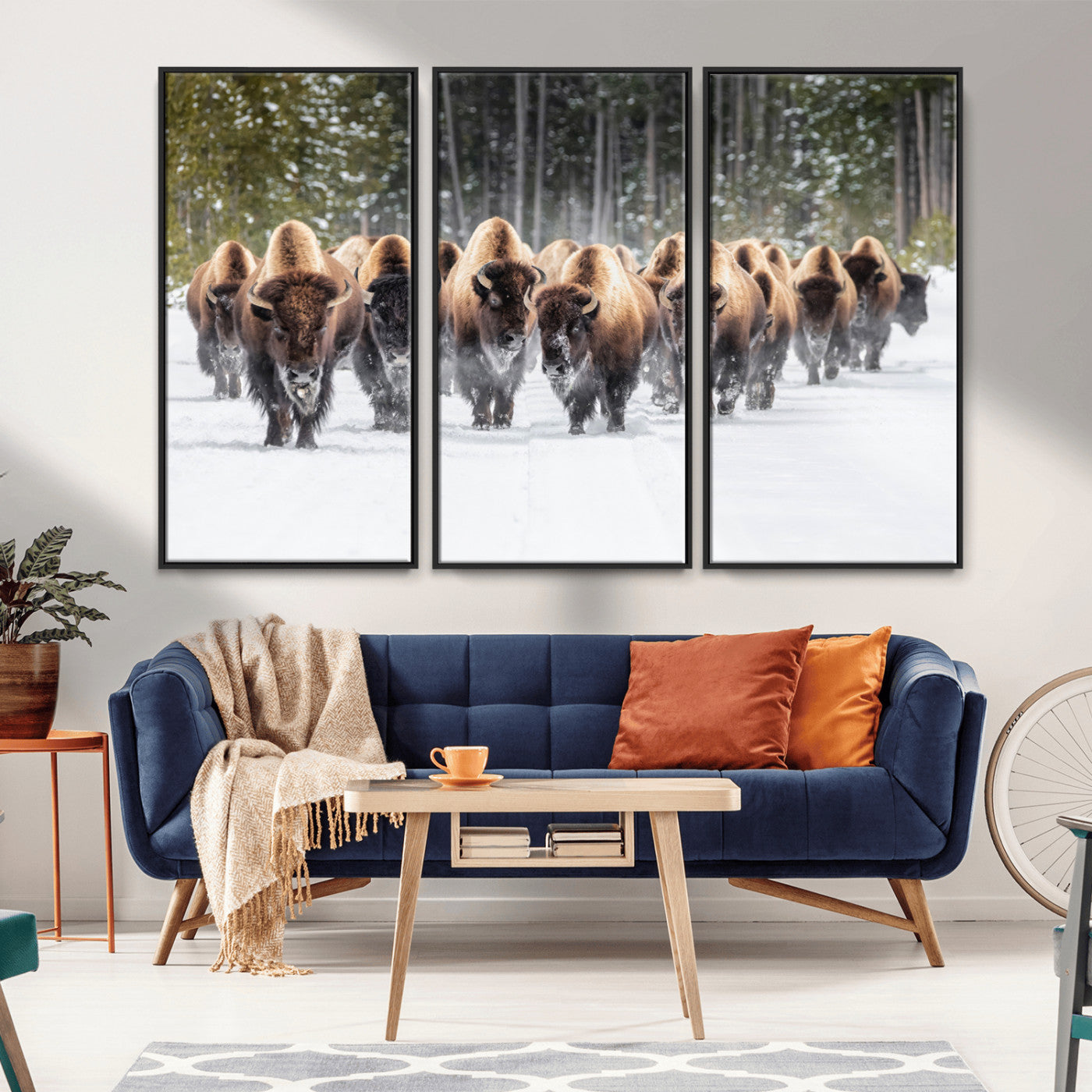 A herd of American bisons walking through a snowy forest path, perfect for rustic cabin or Western-themed wall decor.
