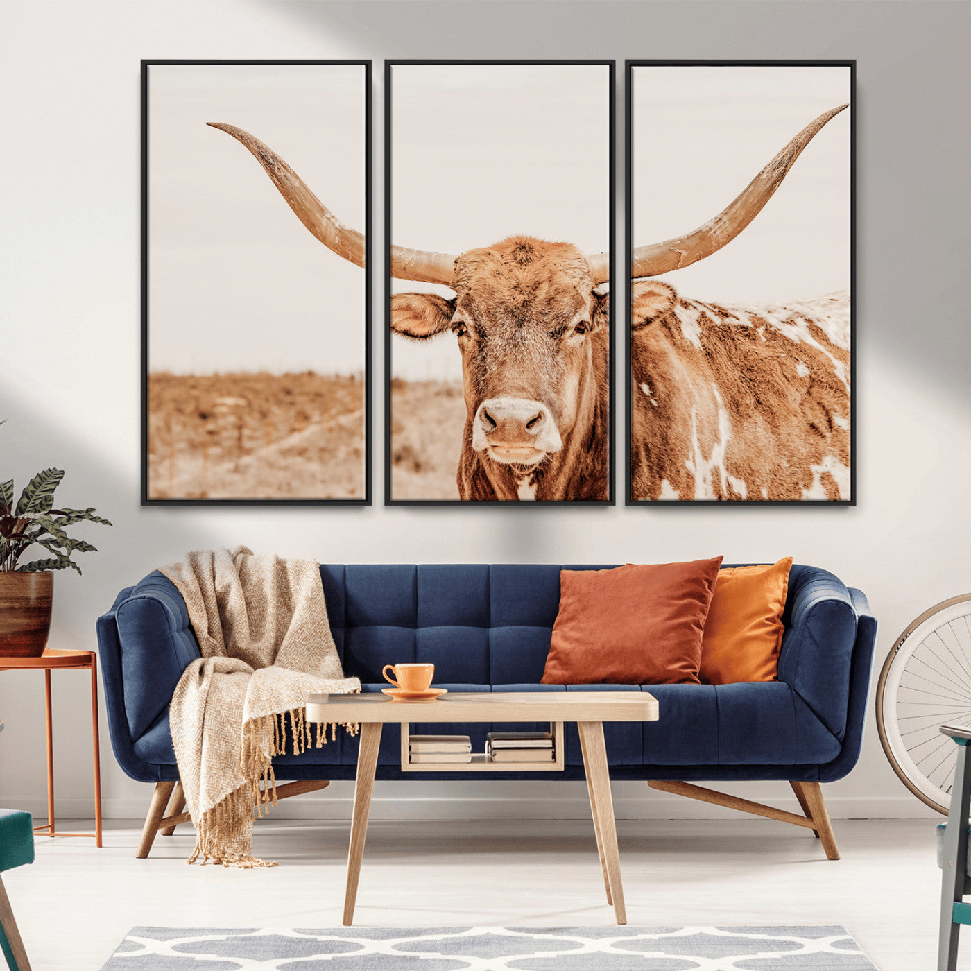 A longhorn bull standing proudly in a sunlit desert field with warm neutral tones, ideal for rustic western or farmhouse interiors.