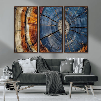 A stunning close-up view of a tree trunk, showcasing the intricate growth rings in a vibrant mix of warm browns, cool blues, and hints of natural texture.