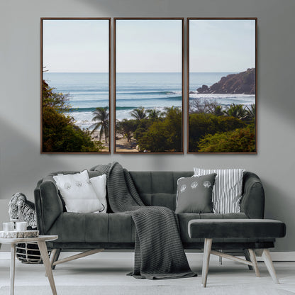 View of calm ocean waves with palm trees and a tropical coastline, ideal for coastal boho or beach-themed wall decor.