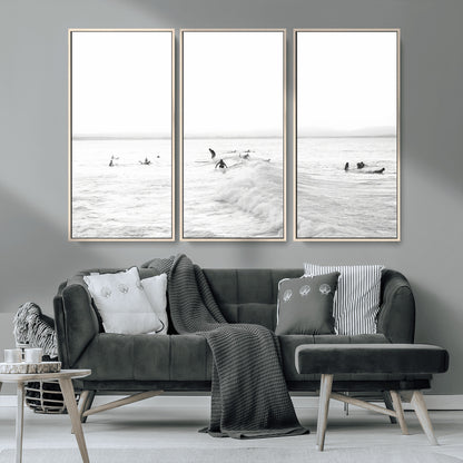 Monochrome photo of surfers riding and waiting on ocean waves, ideal for surf-themed or coastal energy wall decor.