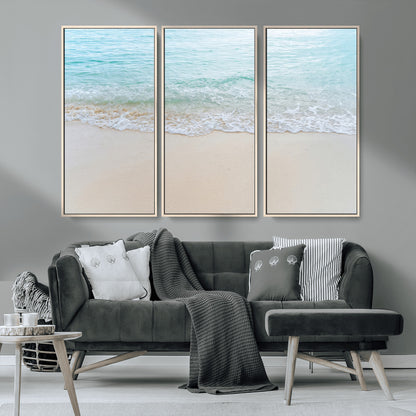 Soft shoreline with gentle aqua waves on smooth sand, ideal for minimalist coastal or pastel ocean-inspired home wall decor.