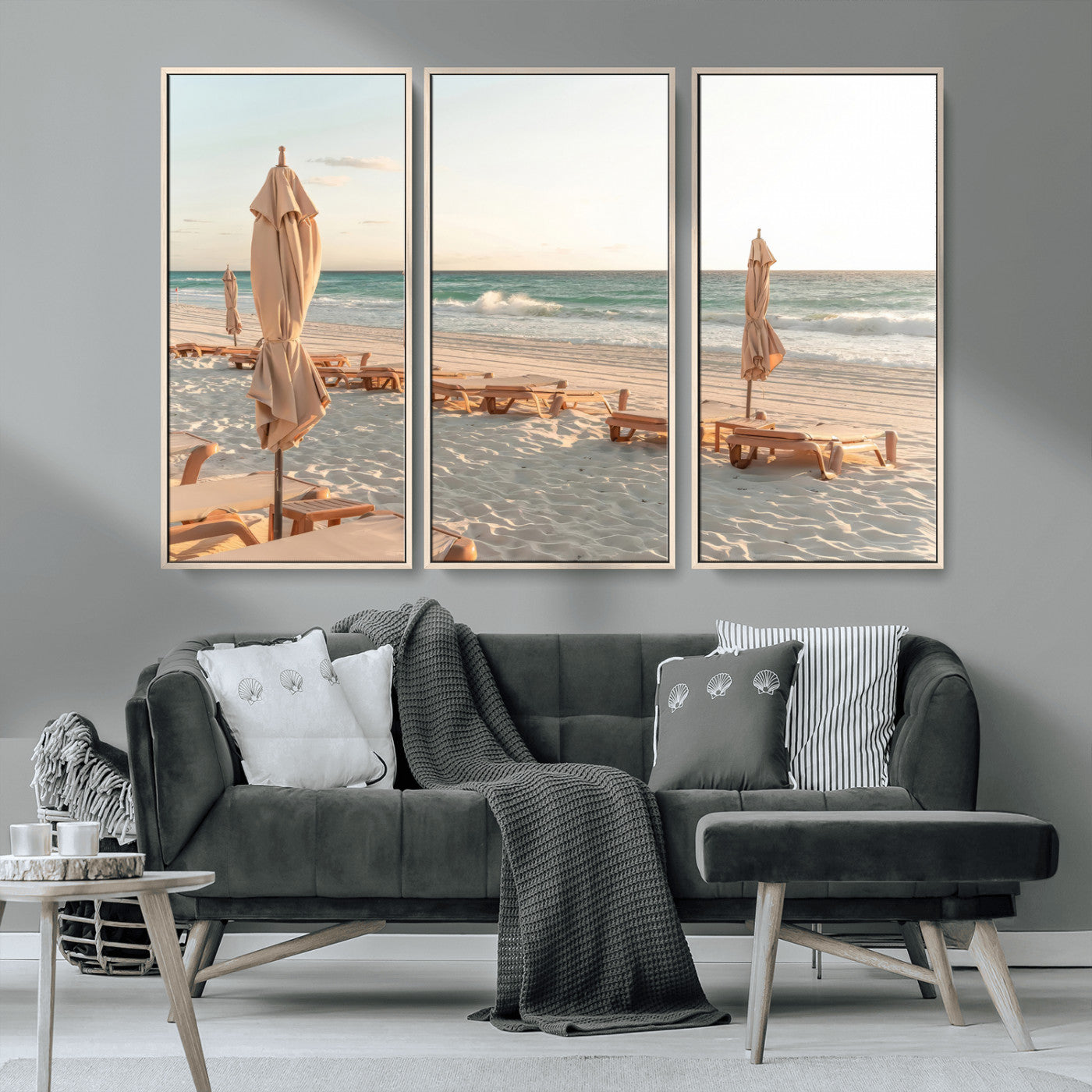 Minimalist photo of empty beach loungers and umbrellas on soft sand, ideal for calm seaside or pastel coastal-style home decor.