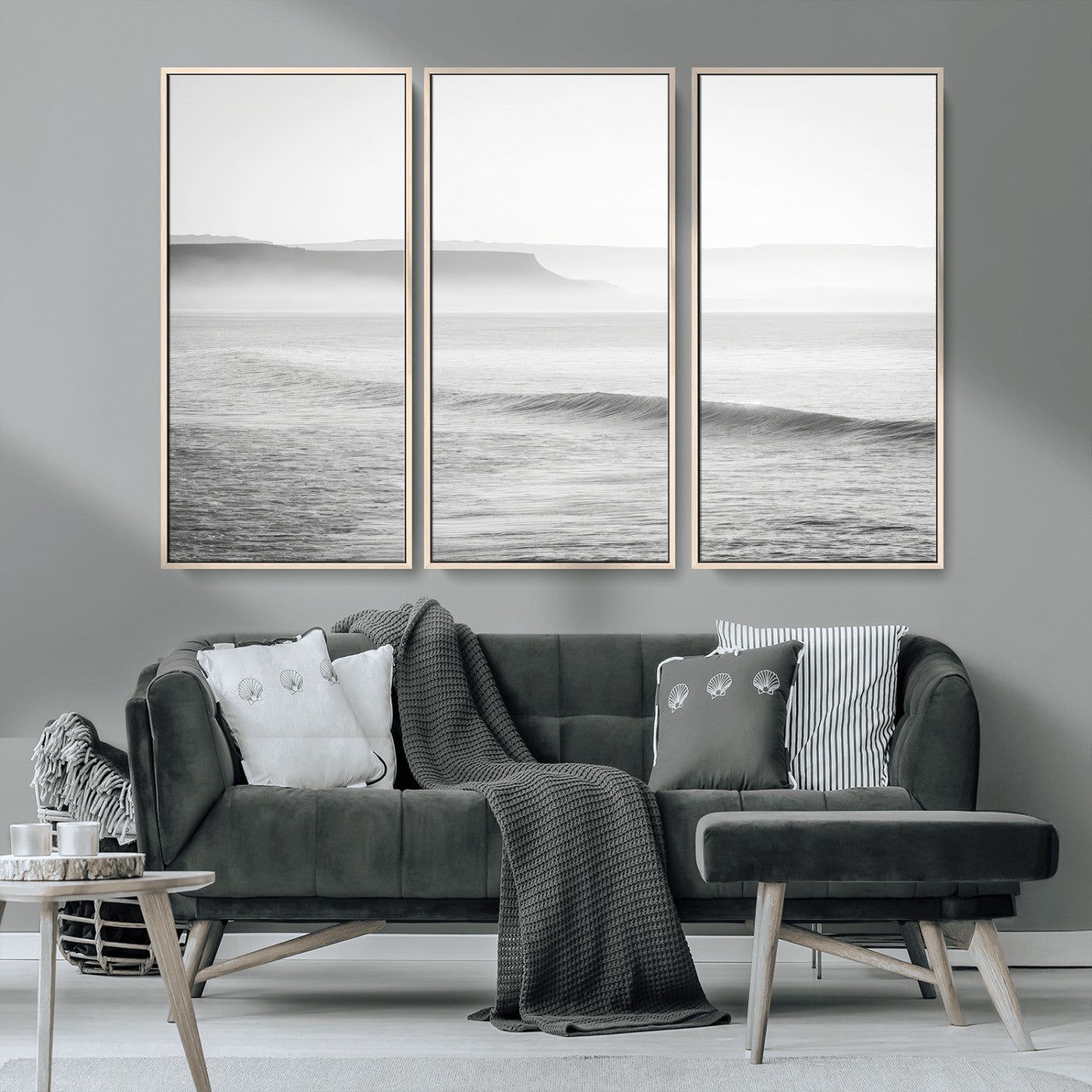 A black and white minimalist seascape featuring soft rolling waves and misty distant cliffs, creating a serene and timeless coastal atmosphere.