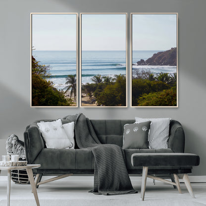 View of calm ocean waves with palm trees and a tropical coastline, ideal for coastal boho or beach-themed wall decor.