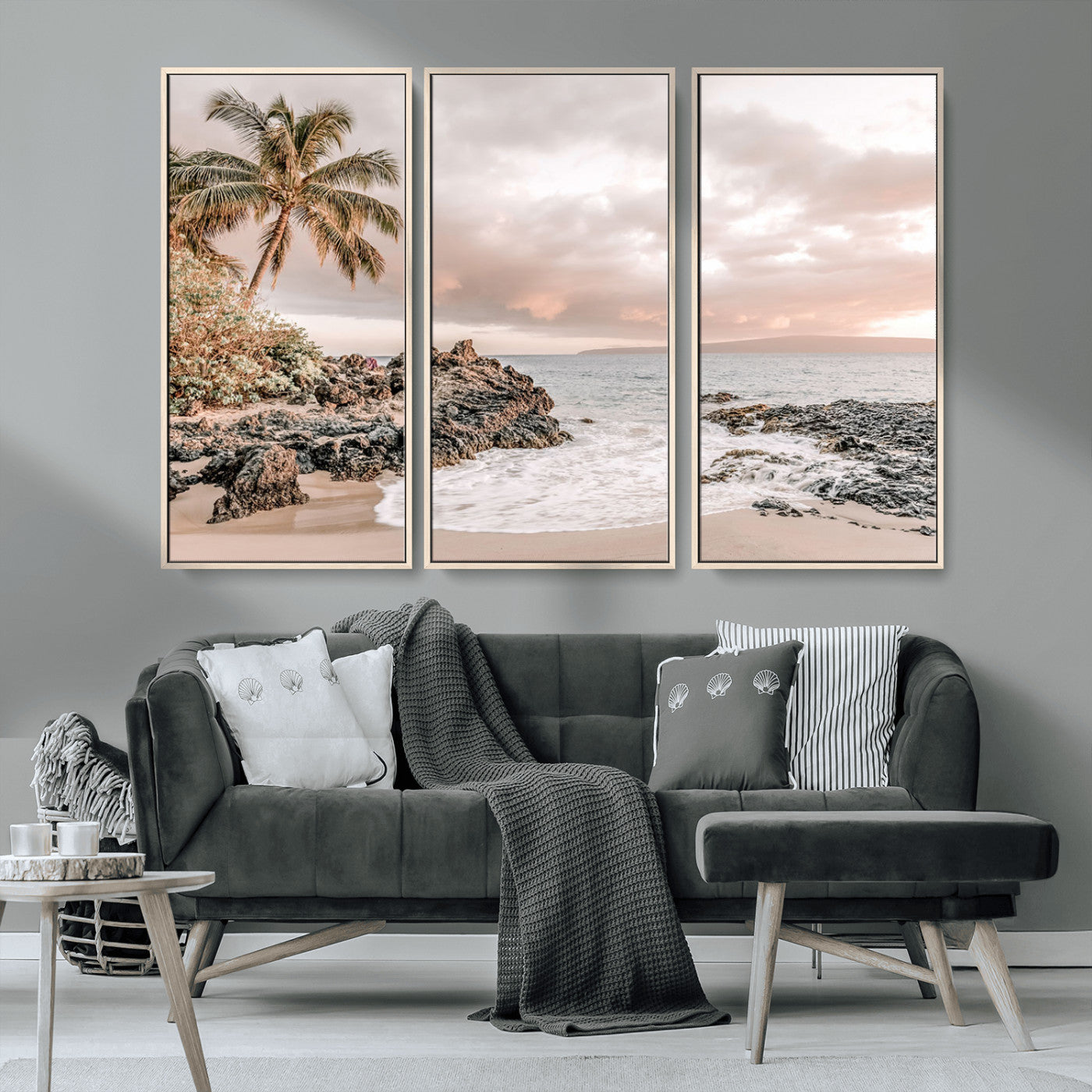 A peaceful beach scene with a palm tree and rocks, soft waves washing onto the shore under a soft pastel sky at sunset.