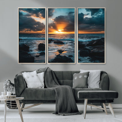 An awe-inspiring sunset over the ocean with rays of light piercing through dramatic clouds, creating a beautiful seascape with rocks in the foreground.