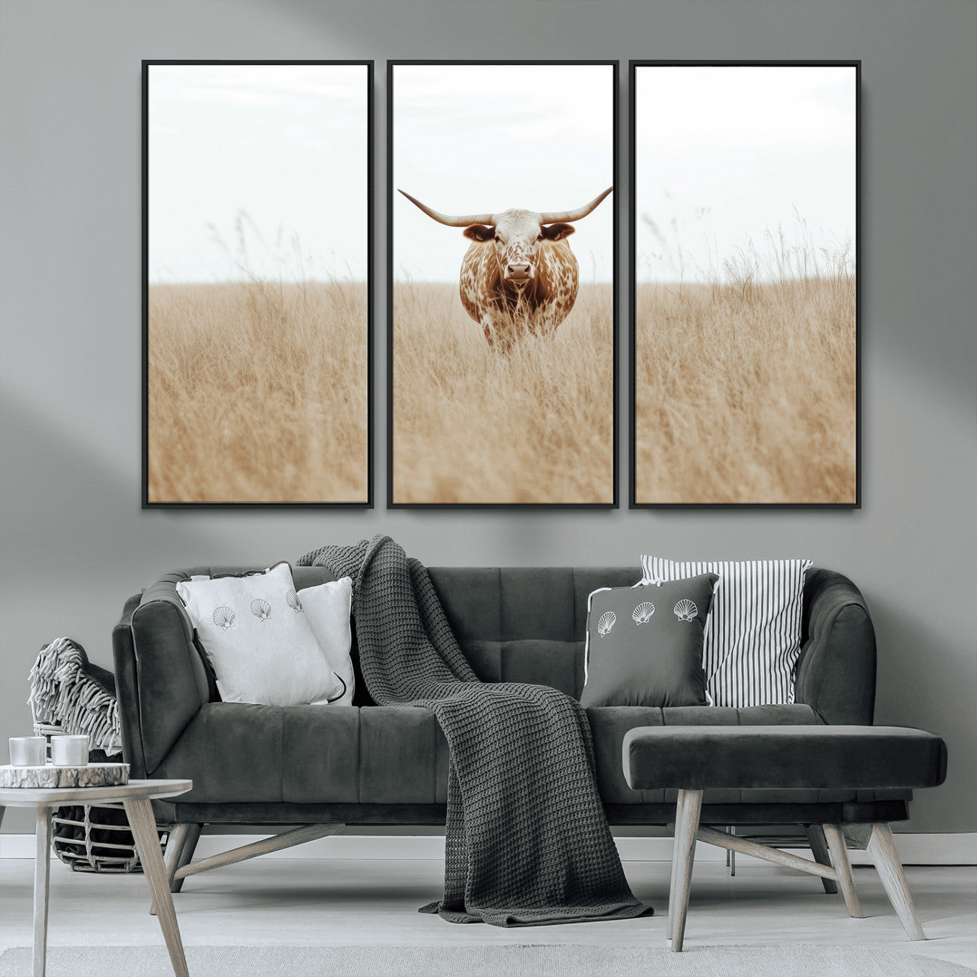 Texas Longhorn bull standing alone in dry grass with neutral tones, ideal for rustic western or cowboy-themed wall decor.