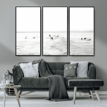 Monochrome photo of surfers riding and waiting on ocean waves, ideal for surf-themed or coastal energy wall decor.