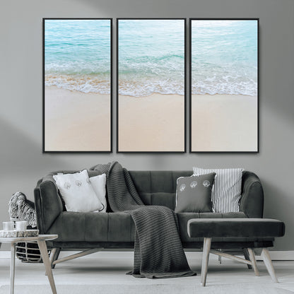 Soft shoreline with gentle aqua waves on smooth sand, ideal for minimalist coastal or pastel ocean-inspired home wall decor.