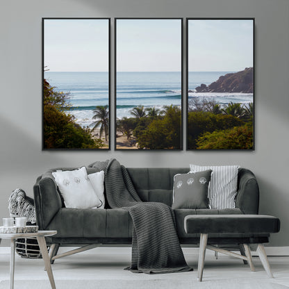 View of calm ocean waves with palm trees and a tropical coastline, ideal for coastal boho or beach-themed wall decor.