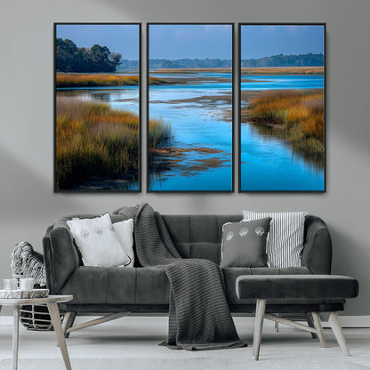 A peaceful marshland scene with calm blue water reflecting the surrounding grasses and trees, capturing the beauty of nature in a serene landscape.