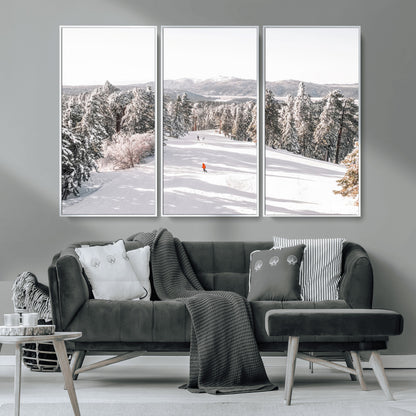 Bright ski trail lined with snow-covered pines and a skier in orange, perfect for alpine adventure or winter sports-inspired decor.