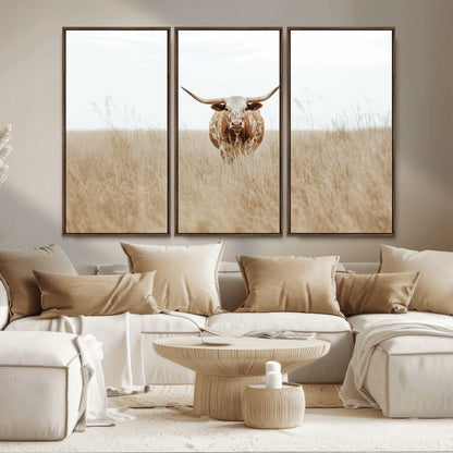 Texas Longhorn bull standing alone in dry grass with neutral tones, ideal for rustic western or cowboy-themed wall decor.