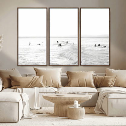Monochrome photo of surfers riding and waiting on ocean waves, ideal for surf-themed or coastal energy wall decor.