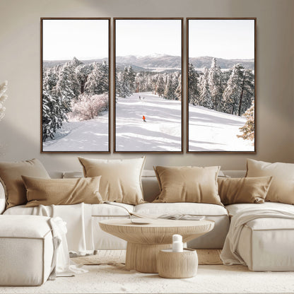 Bright ski trail lined with snow-covered pines and a skier in orange, perfect for alpine adventure or winter sports-inspired decor.